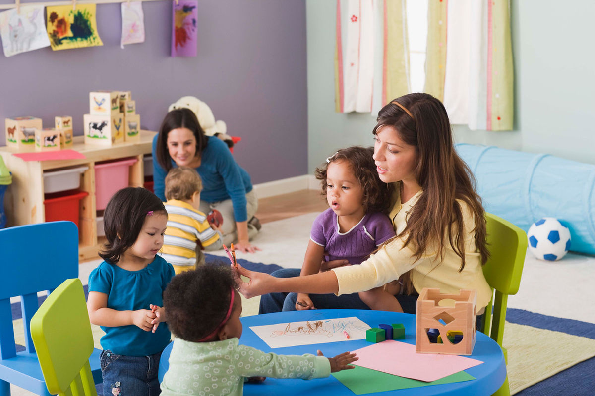 A parent sitting with their child, beginning to learn about ABA therapy together